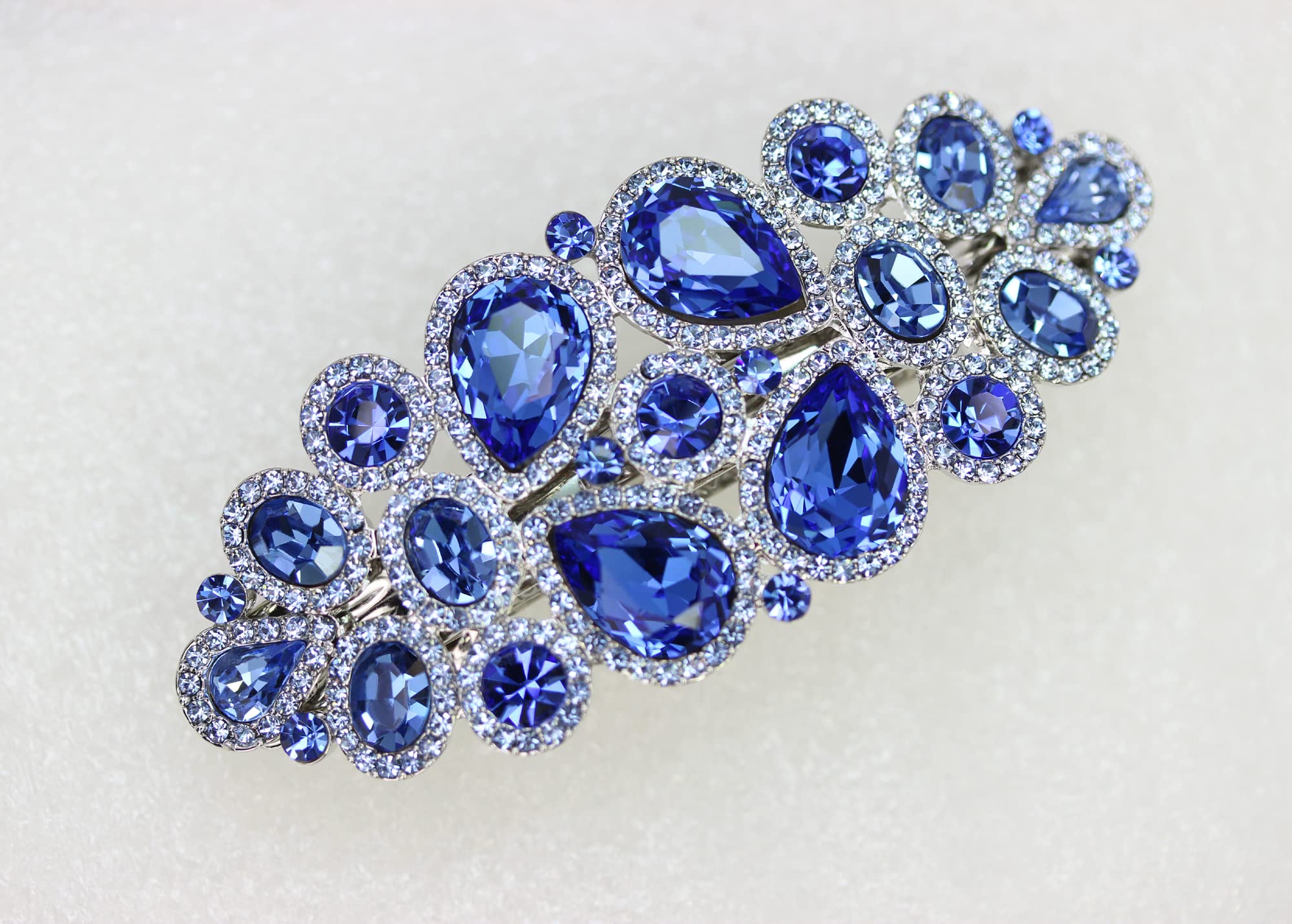 Faship blue hair clip on model demonstrates elegant formal styling.
