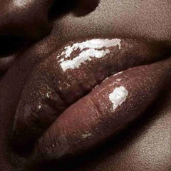 Lips wearing Gloss Bomb for mirror-like shine and subtle volume.
