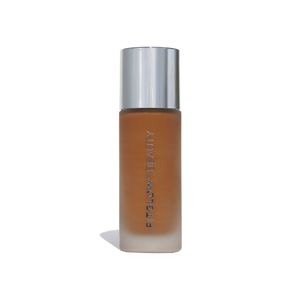 Fitglow Beauty Foundation+ bottle close-up shows vegan packaging for a natural finish