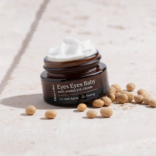 Fleur & Bee eye cream tube on fingers, ready for quick under-eye application.