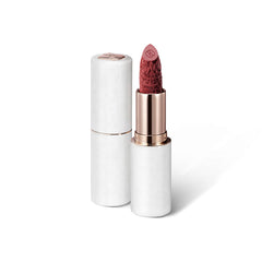 Textured application shot of FLORASIS Blooming Rouge Plum Royale lip color for smooth glide