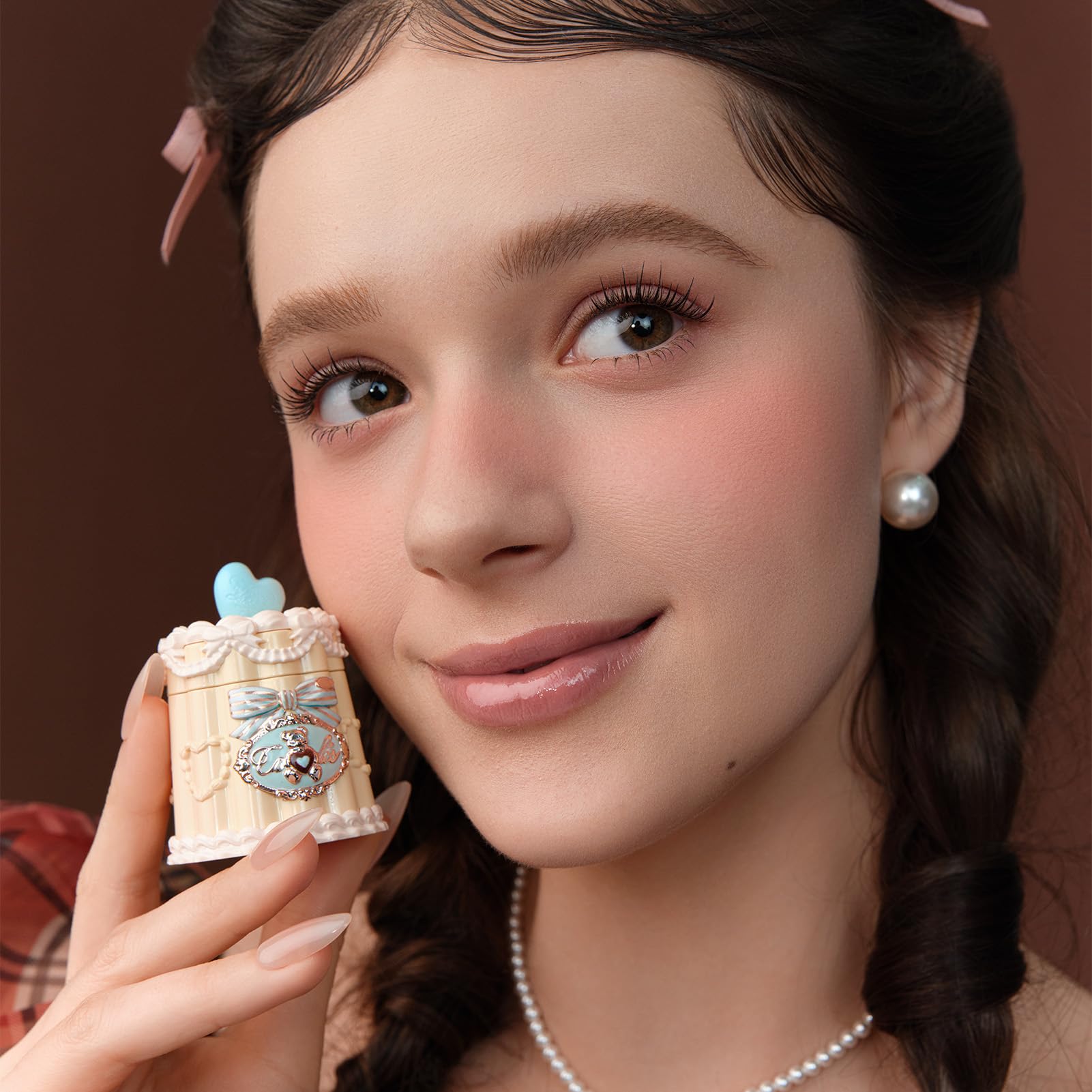 Dispense shot of Flower Knows Sweetie Bear Lip Jelly on fingertips