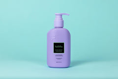 Folliflo Hair Boost Conditioner in use during shower for daily care.
