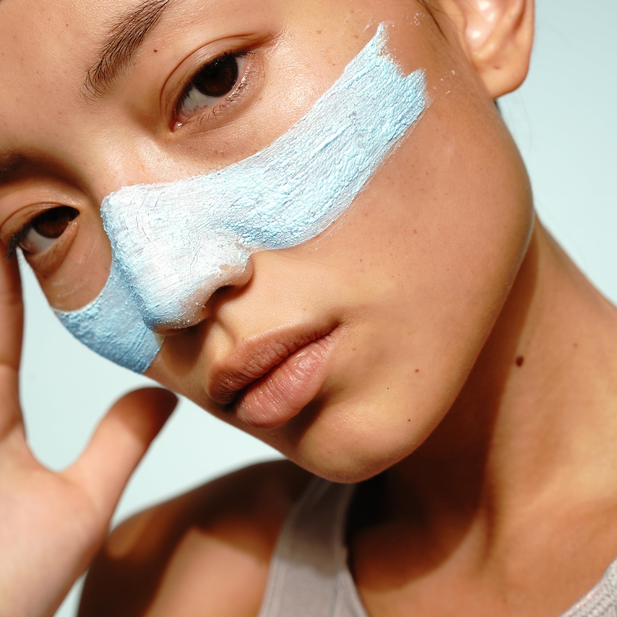 FRÉ Exfoliating Acne Face Mask texture swirl on skin with creamy paste