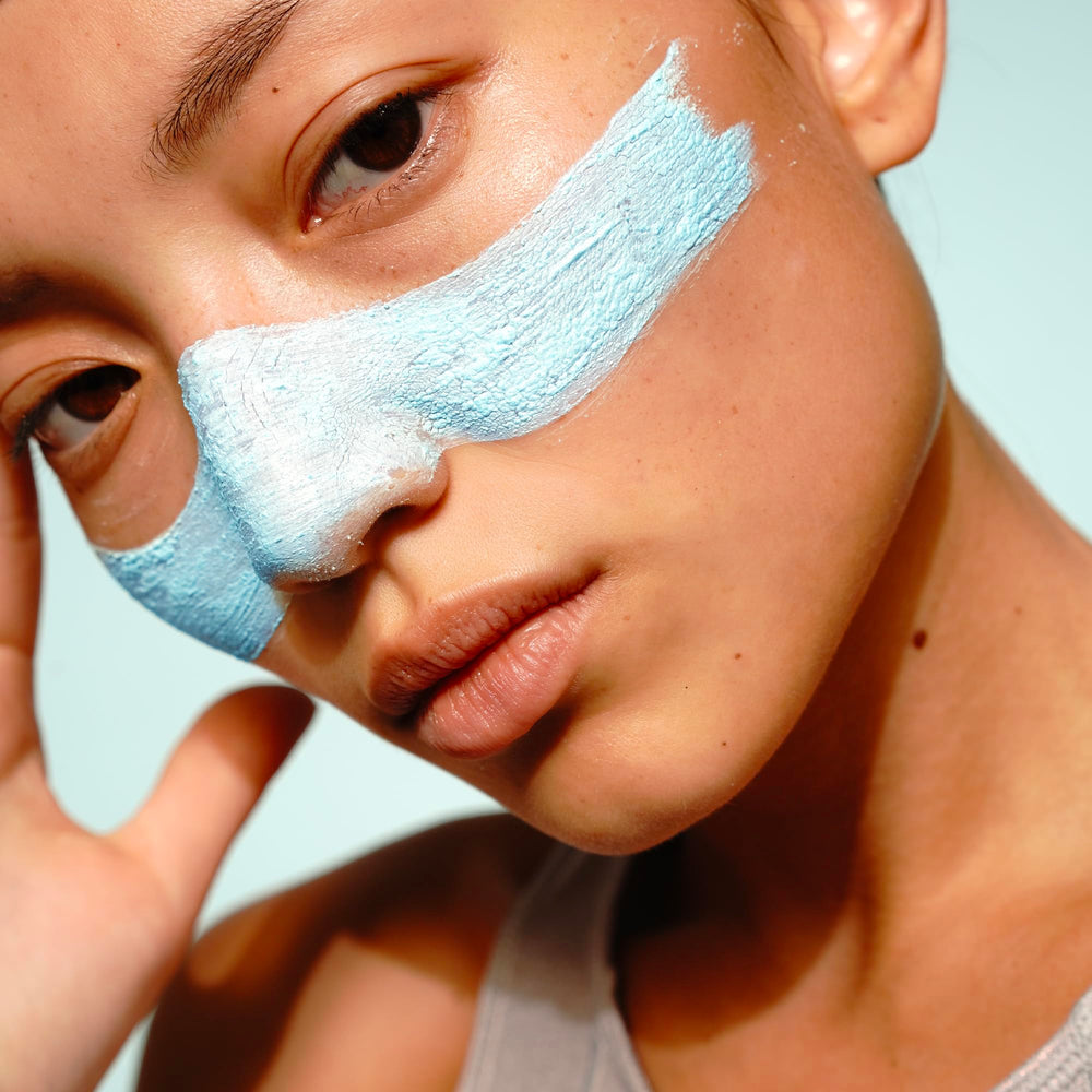 FRÉ Exfoliating Acne Face Mask texture swirl on skin with creamy paste