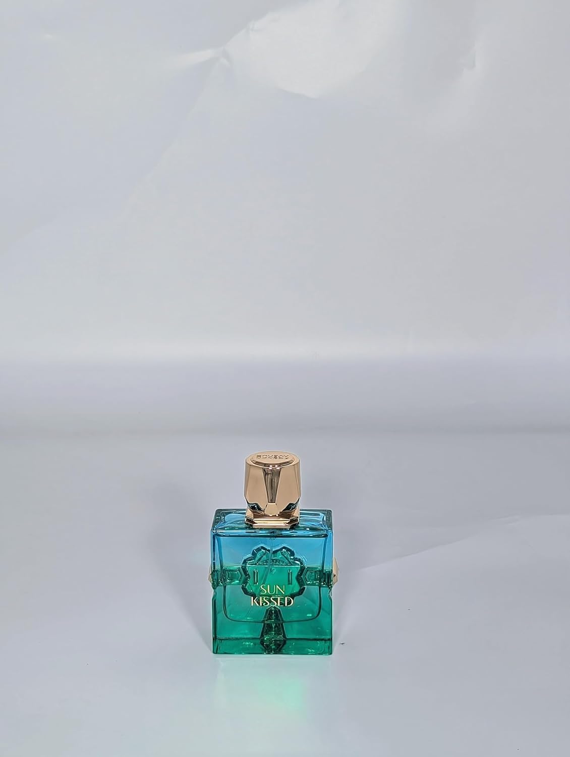 Sun Kissed turquoise glass bottle close-up highlighting premium bottle design