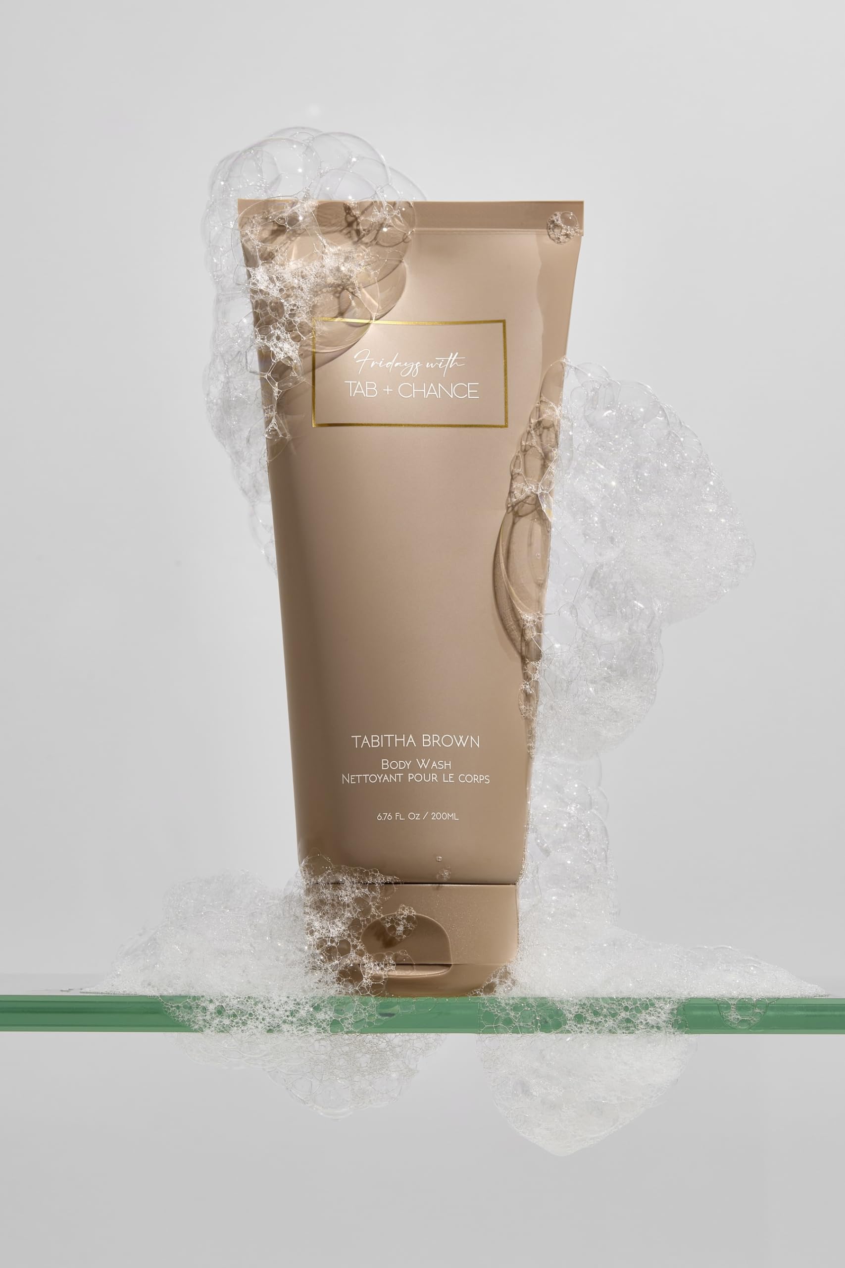 FRIDAYS Her Business Body Wash bottle being poured, releasing a mood-lifting fragrance.