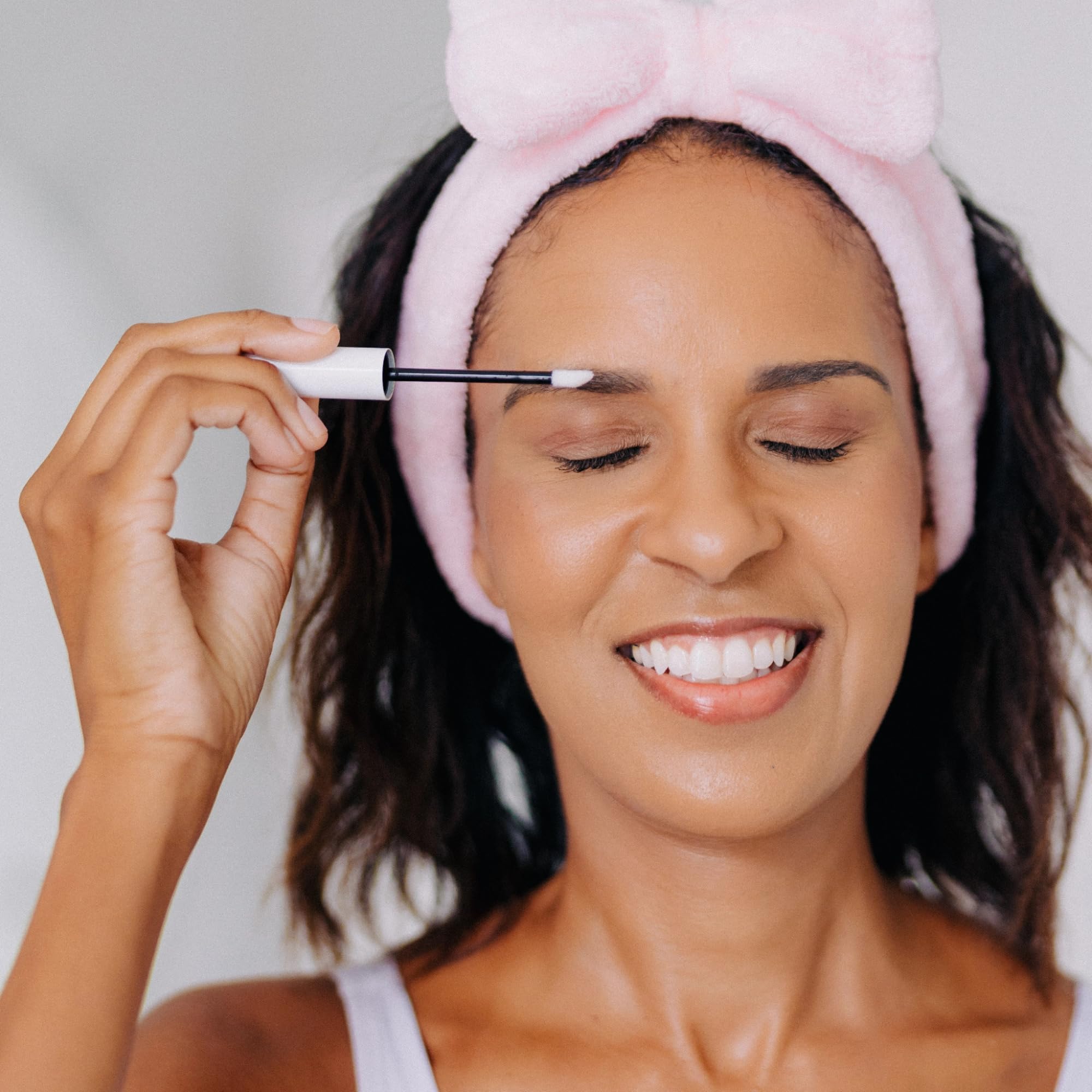Frownies Brow Serum bottle with applicator for easy nightly use.