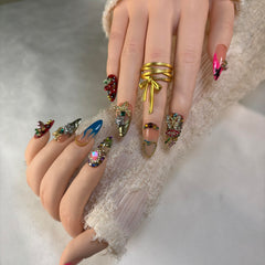 Furnunubi almond press-on nails featuring crystal hearts and 3D flowers for luxe detail.