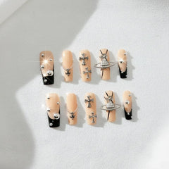 FURNUNUBI square press-on nails with black French tip and Saturn charms for a bold Gothic look