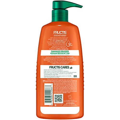 Close-up of Damage Eraser shampoo label highlighting Amla Oil benefits for hair.
