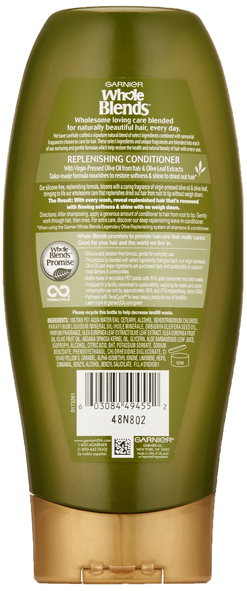 Close-up of the conditioner label highlights virgin-pressed olive oil and olive leaf extracts for wholesome care.