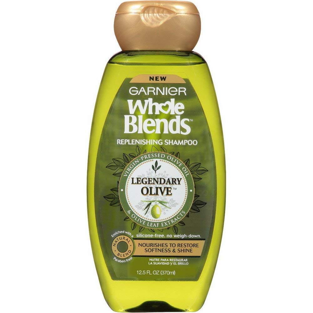 Garnier Whole Blends Legendary Olive shampoo bottle showing nourishing olive oil for dry hair.