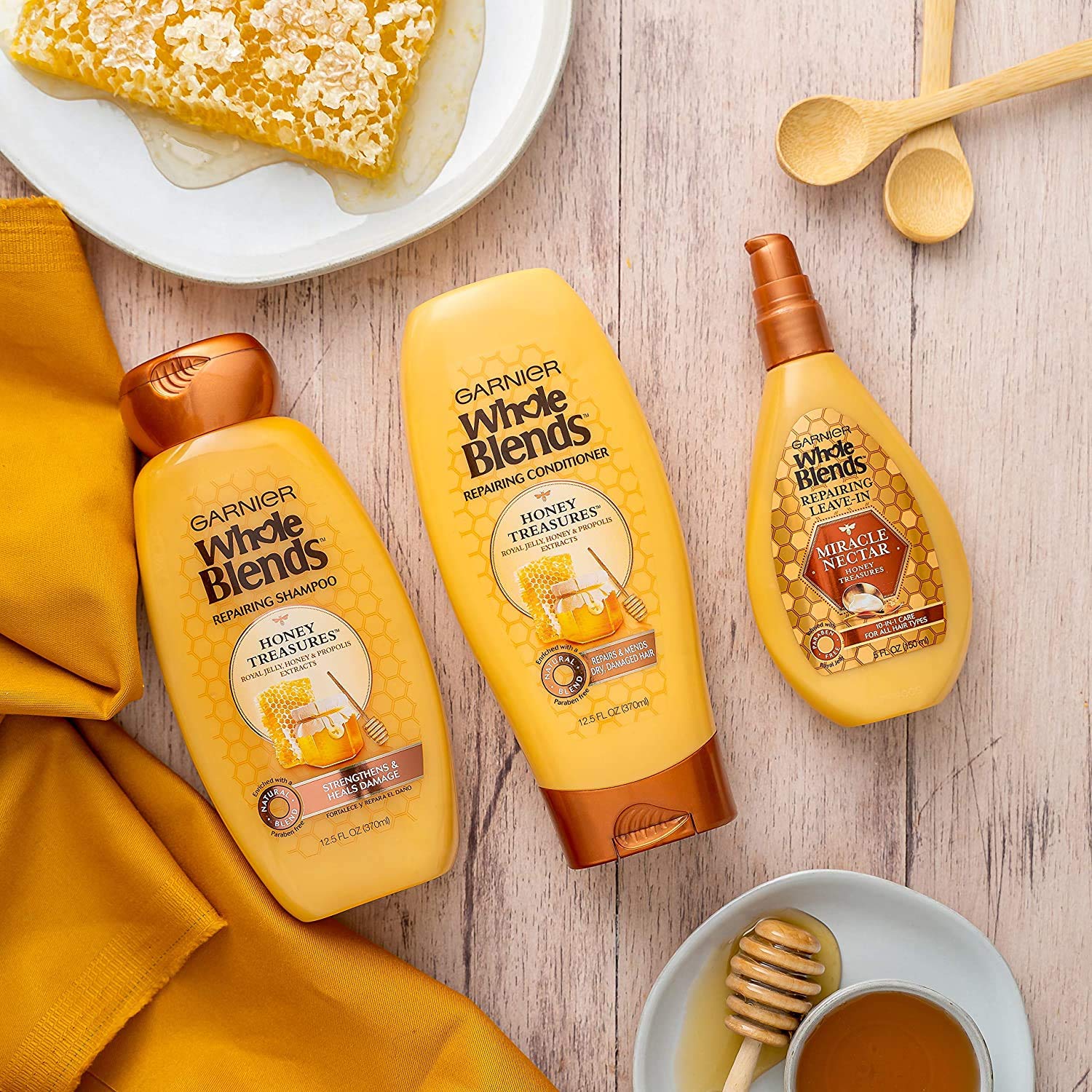 Garnier Whole Blends shampoo bottle paired with Honey Treasures system.