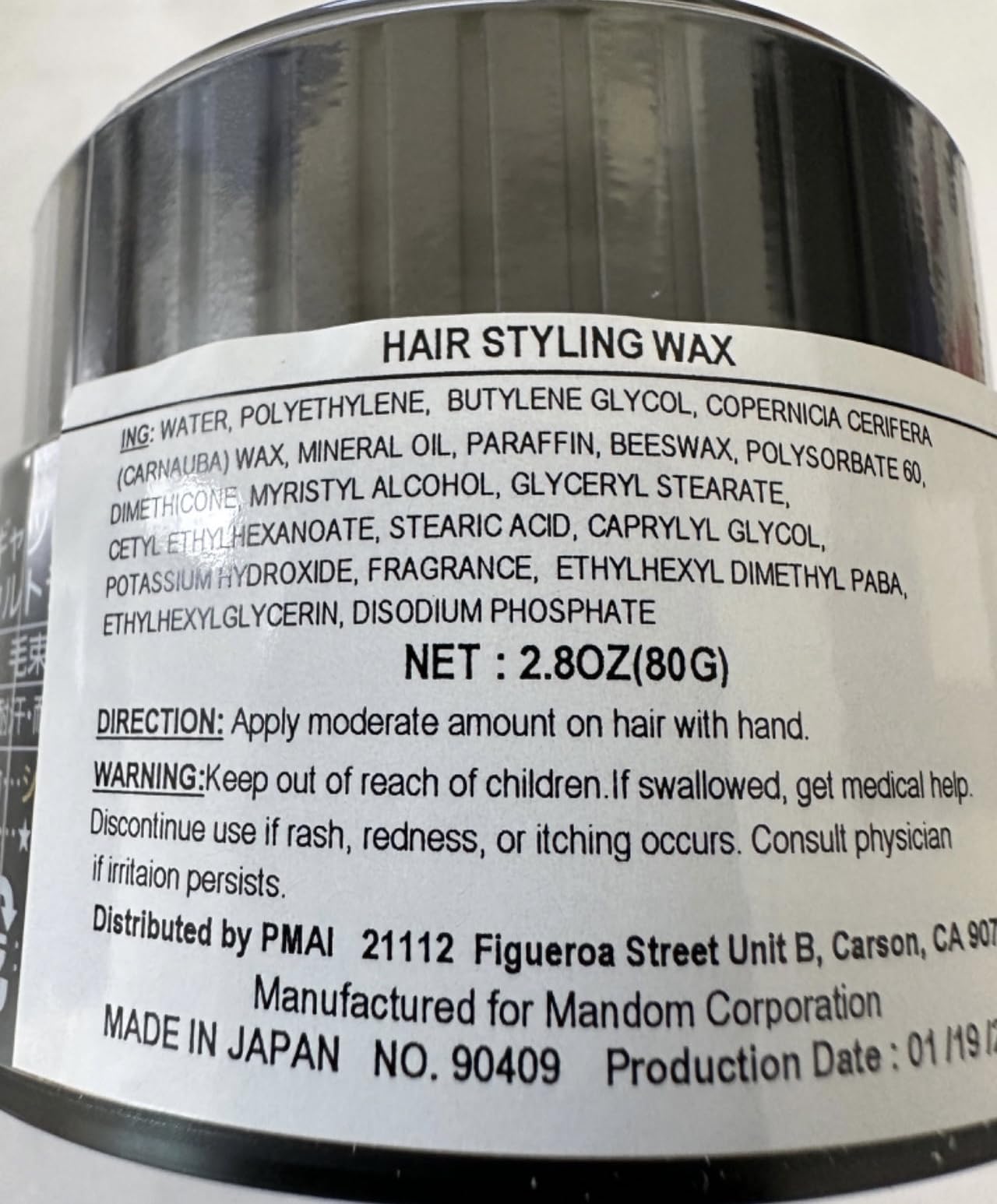 Gatsby Styling Ultra Hard Type Wax in hand for precise shaping.