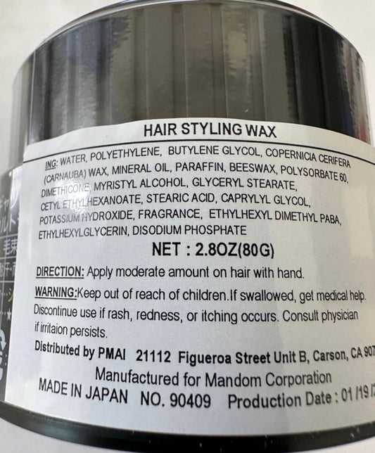 Gatsby Styling Ultra Hard Type Wax in hand for precise shaping.
