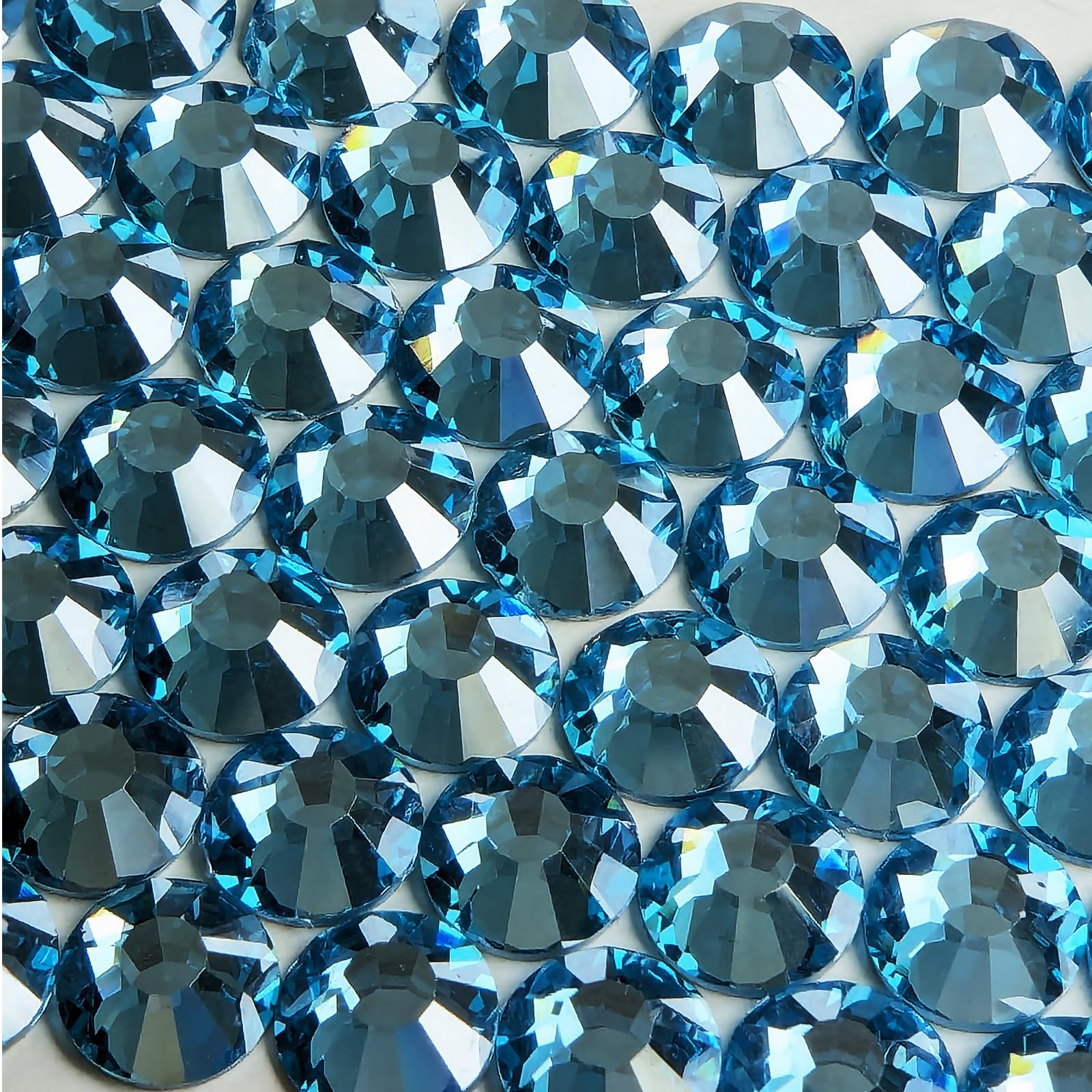 Genie Crystal Ice Aquamarine flatback crystals closeup showing translucent glow.