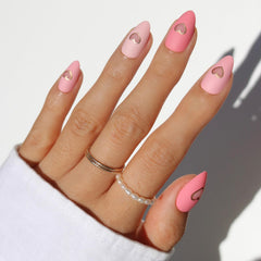Glamnetic Valentines Day nails in matte pink tones with a gold heart accent for chic vibes