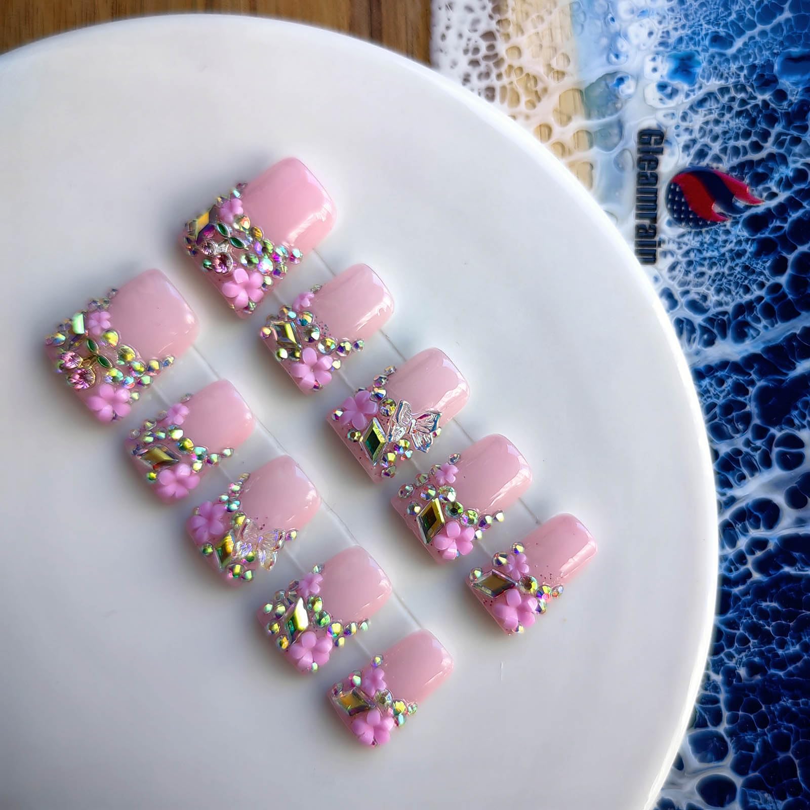 Gleamrain pink press-on nails with 3D floral patterns for decorative depth.