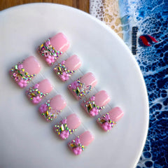 Gleamrain pink press-on nails with 3D floral patterns for decorative depth.