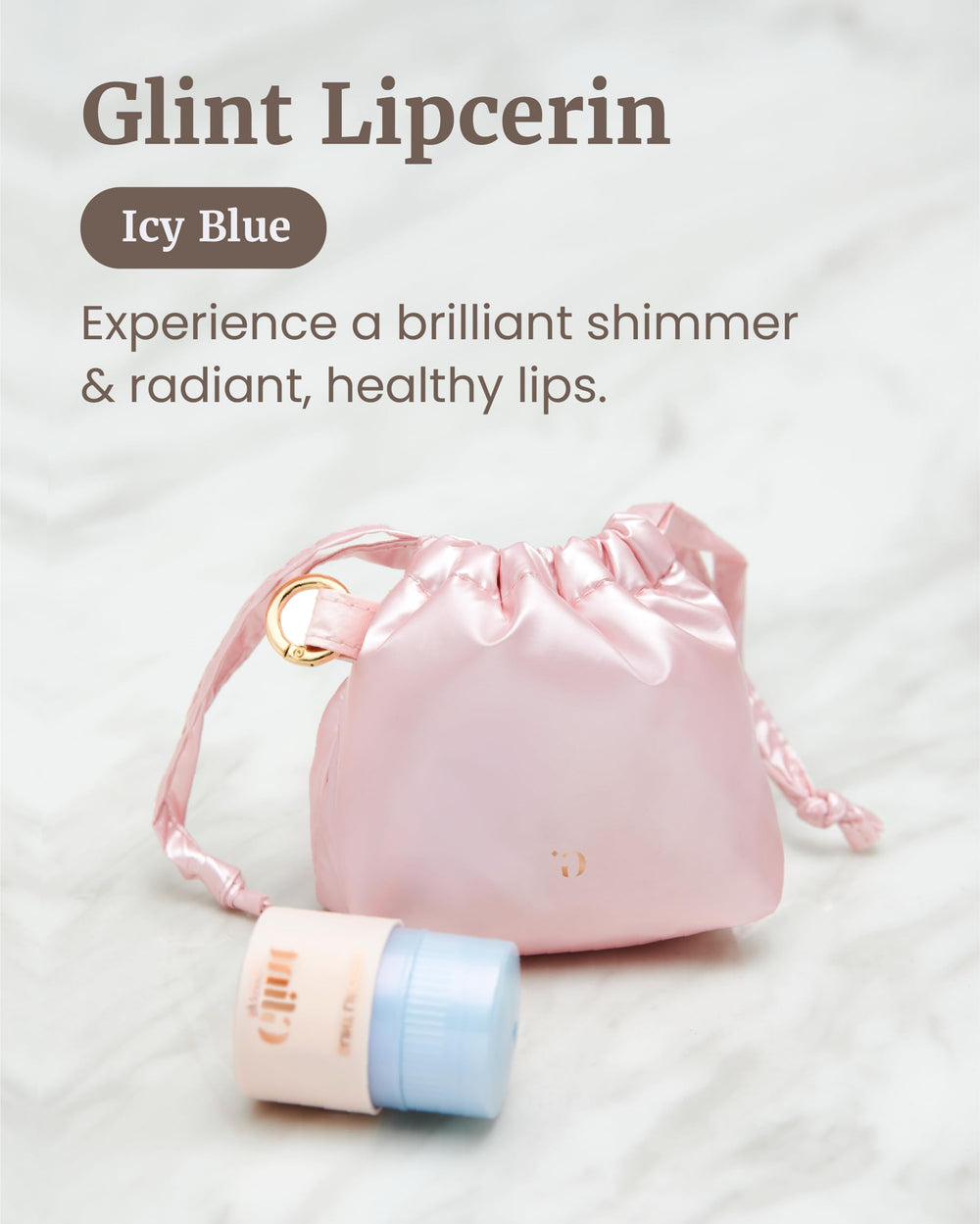 Glint Lipcerin icy blue tube close-up shows pearlescent shimmer