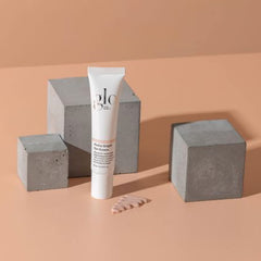 Glo Skin Beauty Hydra-Bright Eye Cream texture swatch showing peach-toned luminosity and radiance