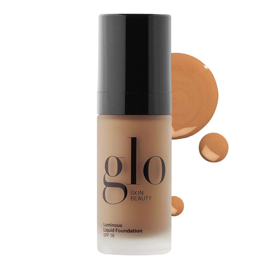 Glo Skin Beauty Luminous Foundation bottle with SPF 18 for radiant, even-toned skin.