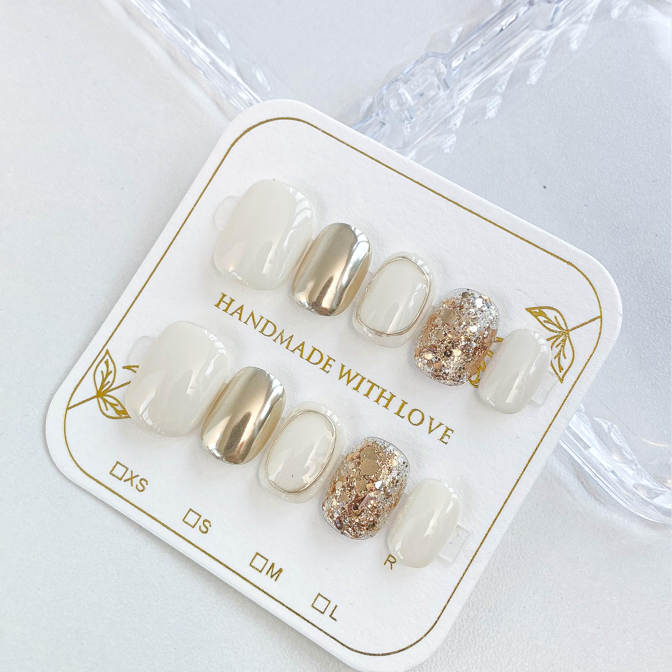 GLORS beige-gold glitter detail on short square nails.