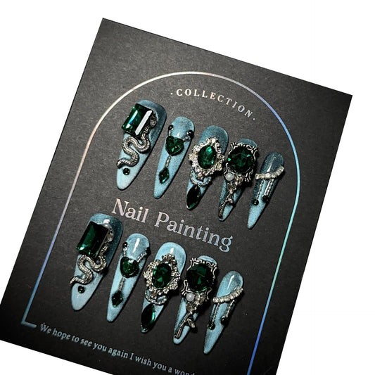 GLORS blue glitter Medusa-inspired long-stiletto nails with rhinestones for dramatic at-home manicure.