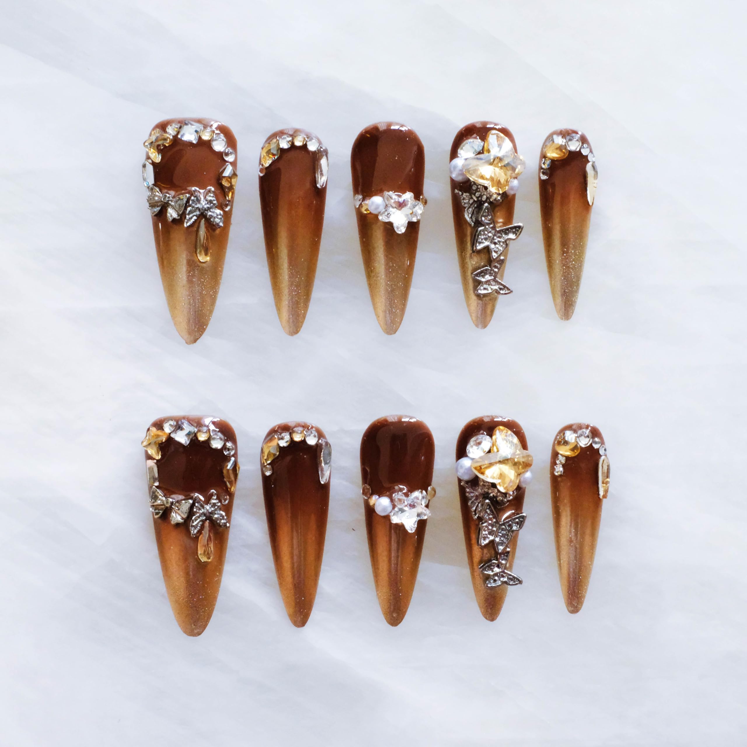 GLORS brown-to-gold ombre stiletto nails with 3D rhinestones for a dramatic look