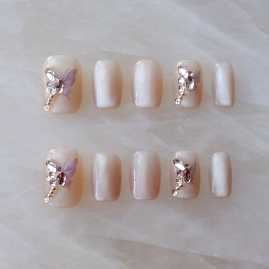 GLORS butterfly nails close-up highlighting butterfly details for a statement manicure