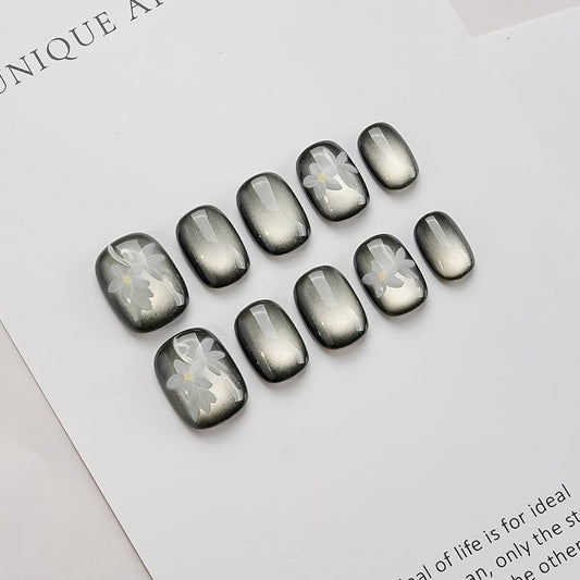GLORS cateye black nails with white flowers for an at-home manicure boost