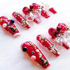 GLORS nails red base with white bows for elegant seasonal styling.