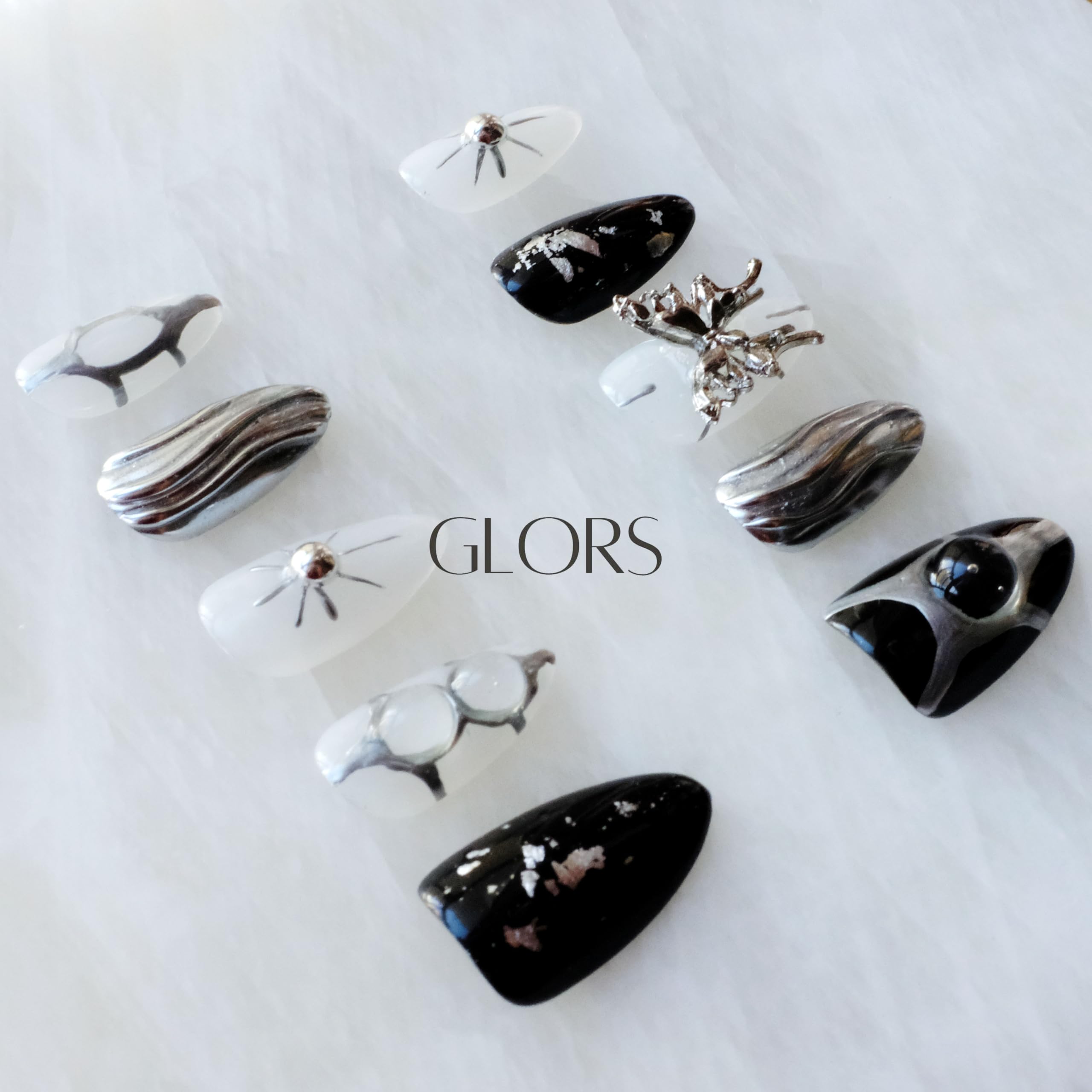 GLORS Gothic long almond nails with chrome swirls for luxe texture