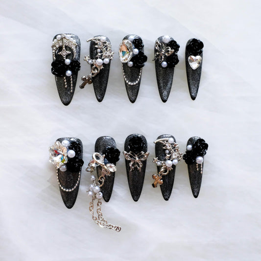 GLORS 3D black roses on long stiletto nails for a dramatic Gothic look.