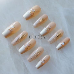 GLORS nails with delicate shell embellishments close-up for luxe style