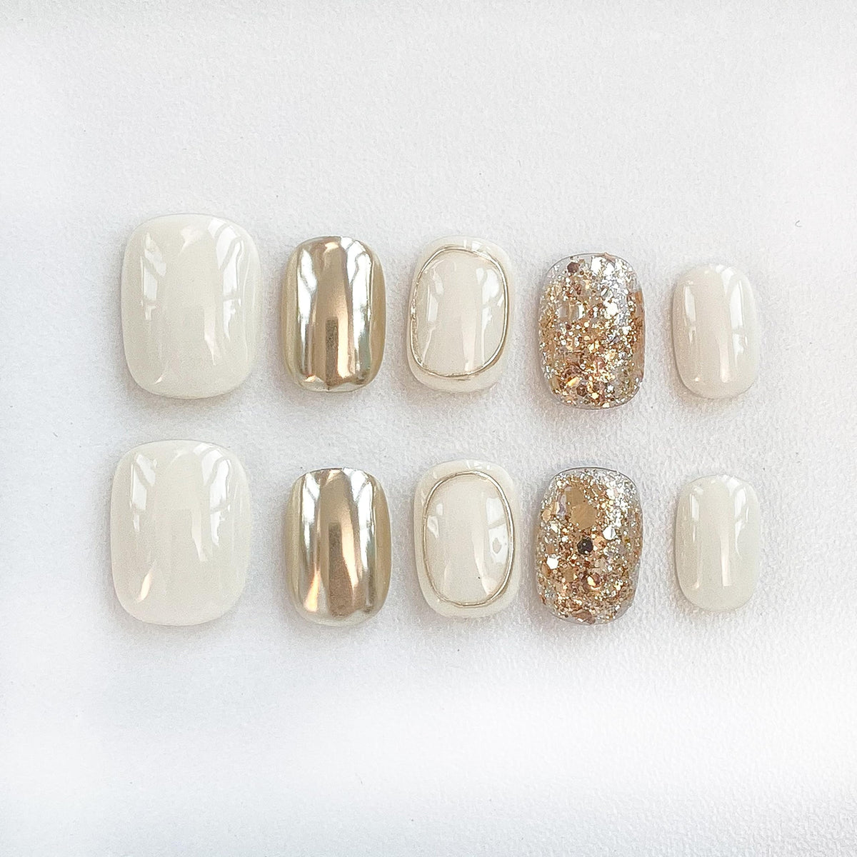 GLORS Purely Handmade nails in beige and gold glitter for elegant daily wear.