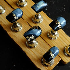 GLORS short square press-ons featuring black-blue marble with gold foil for glamorous looks.