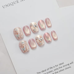 Soft pink shimmer catches light for elegant daily nail looks.
