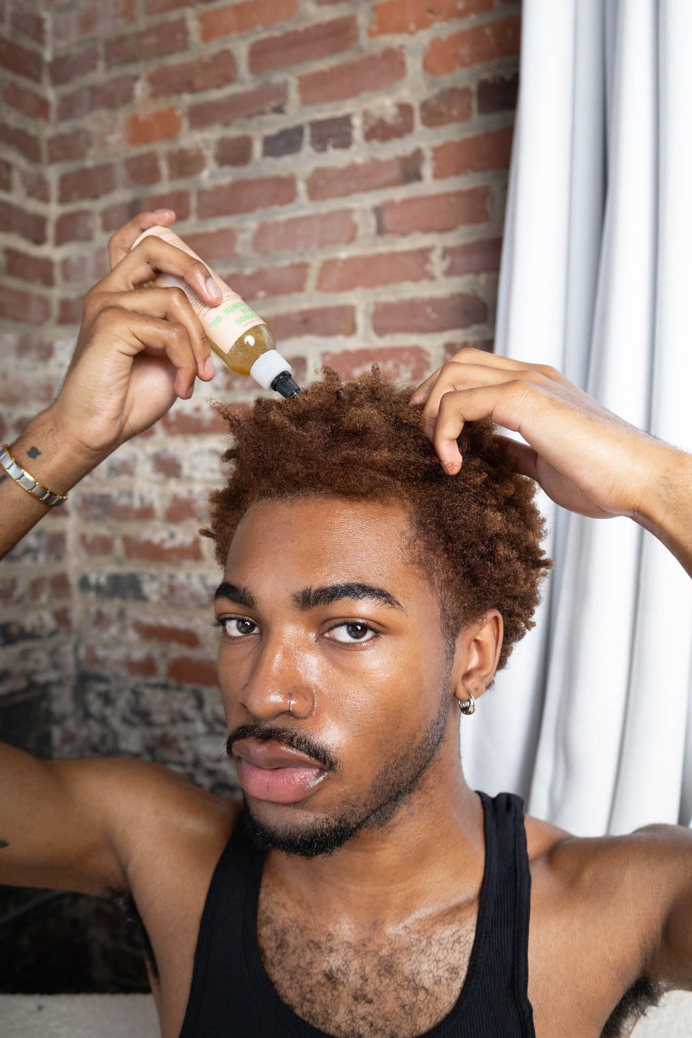 Glossed by Nae Voodoo Hair Growth Oil on shiny hair strands after use.