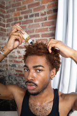 Glossed by Nae Voodoo Hair Growth Oil on shiny hair strands after use.
