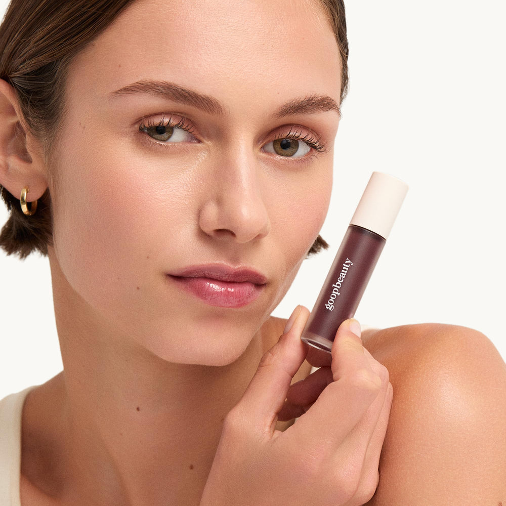 Lifestyle shot of Goop Hydra-Barrier Gel Gloss in a handbag.