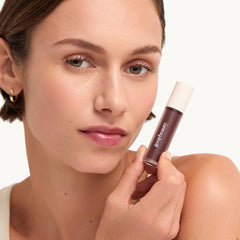 Lifestyle shot of Goop Hydra-Barrier Gel Gloss in a handbag.