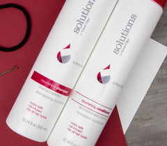 GREAT CLIPS Solutions Nourishing Shampoo color-safe bottle showcases lasting shine and moisture