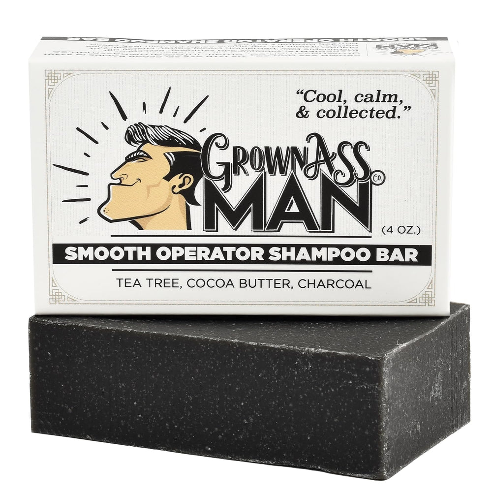 Grown Ass Man Co. Smooth Operator bar close-up shows tea tree and charcoal action.