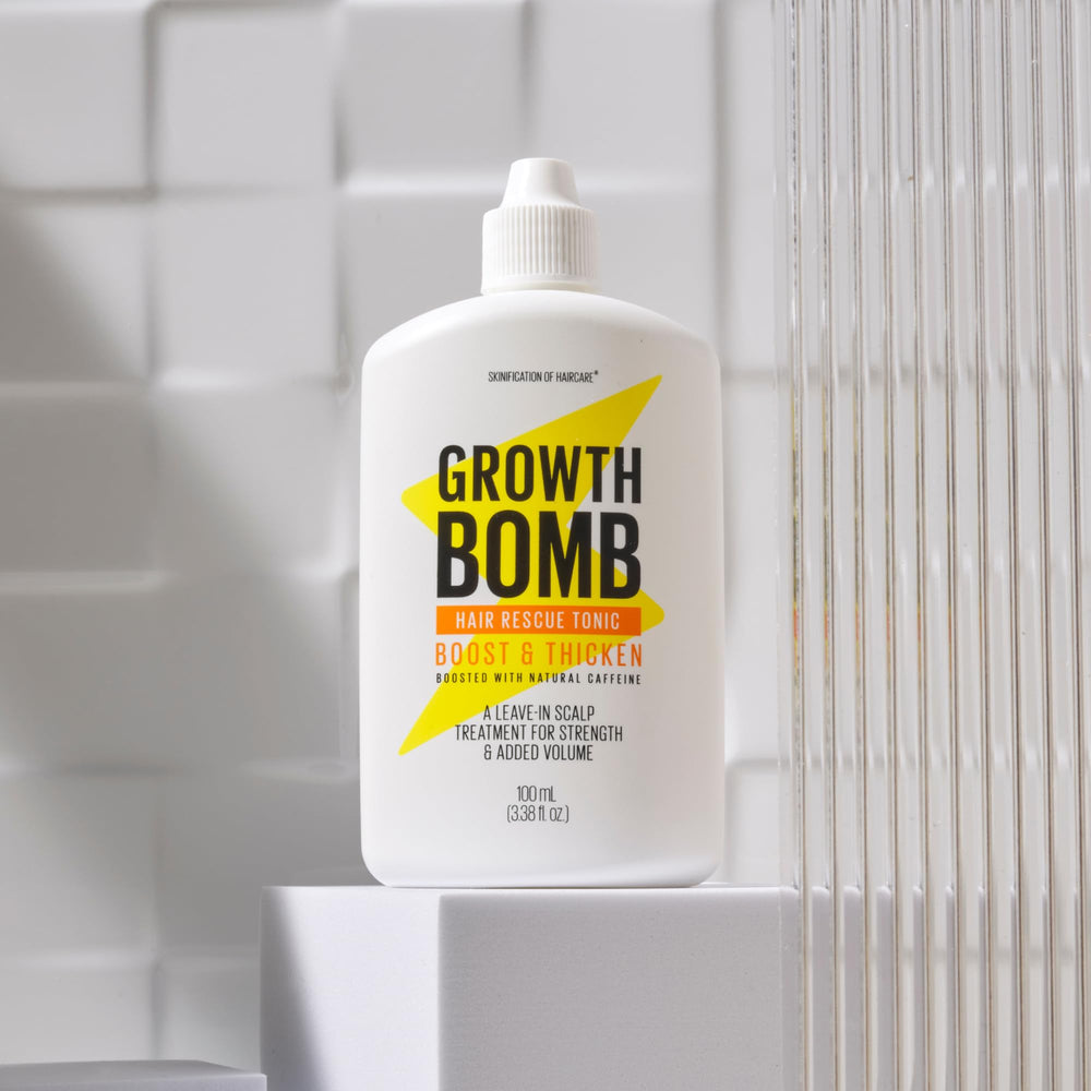 Growth Bomb hair strands closeup highlights strengthened, non-greasy formula across textures.
