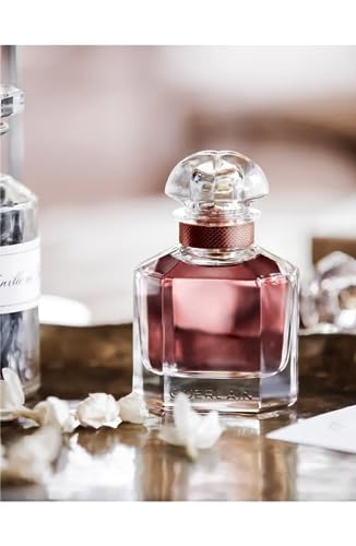 Guerlain Mon Eau de Parfum Intense iris and jasmine detail suggesting refined femininity.