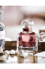 Guerlain Mon Eau de Parfum Intense iris and jasmine detail suggesting refined femininity.