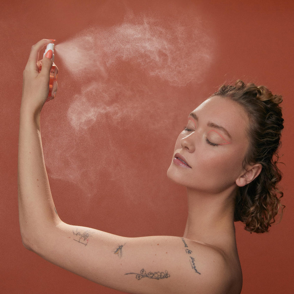 HABIT N°41 sunscreen mist being sprayed over makeup without smudging