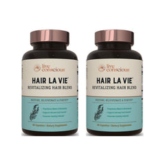 Hair La Vie Revitalizing Blend bottle showcases capsules for hair health.